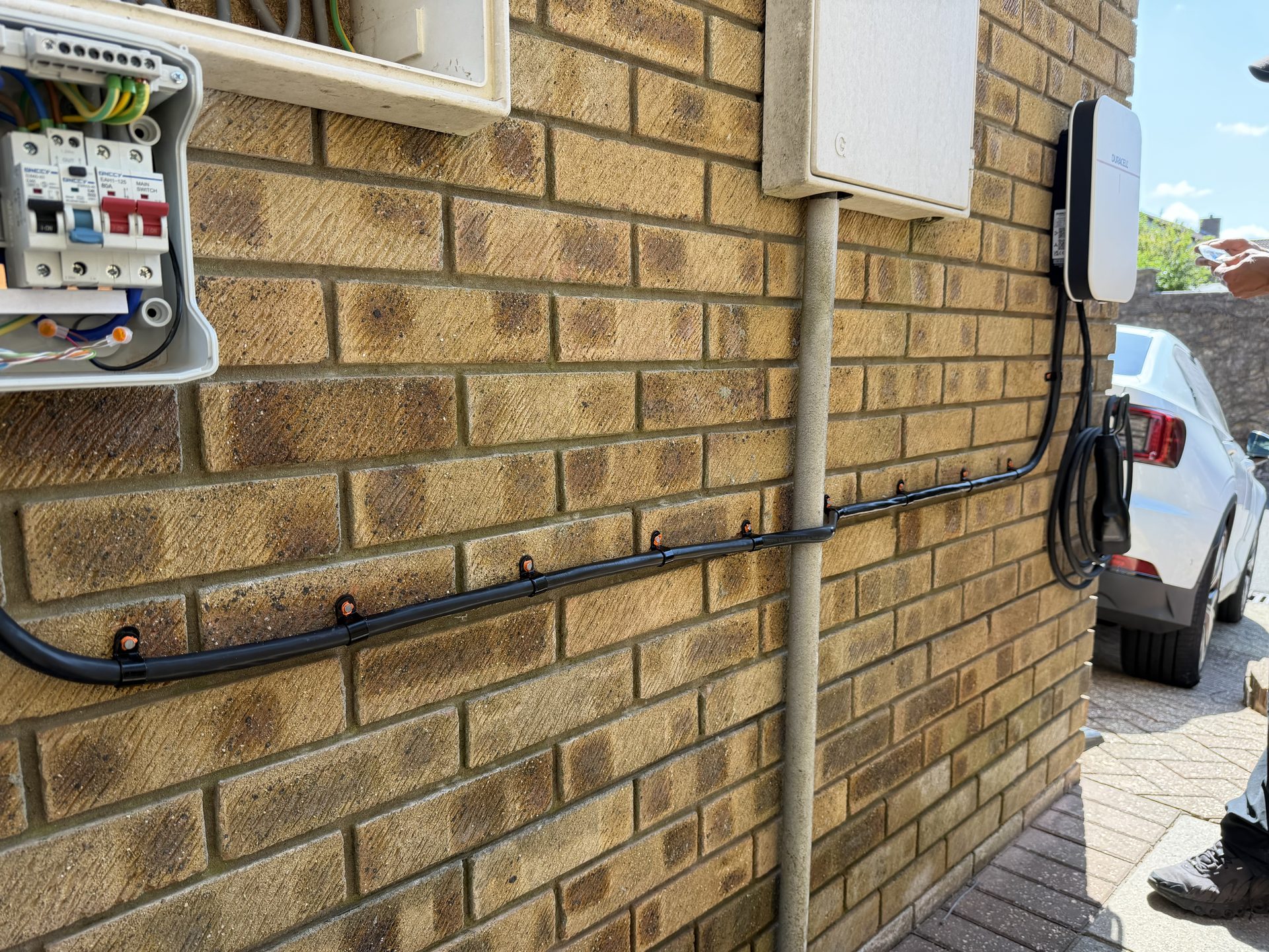 Duracell EV charger installed on an exterior wall, Poole