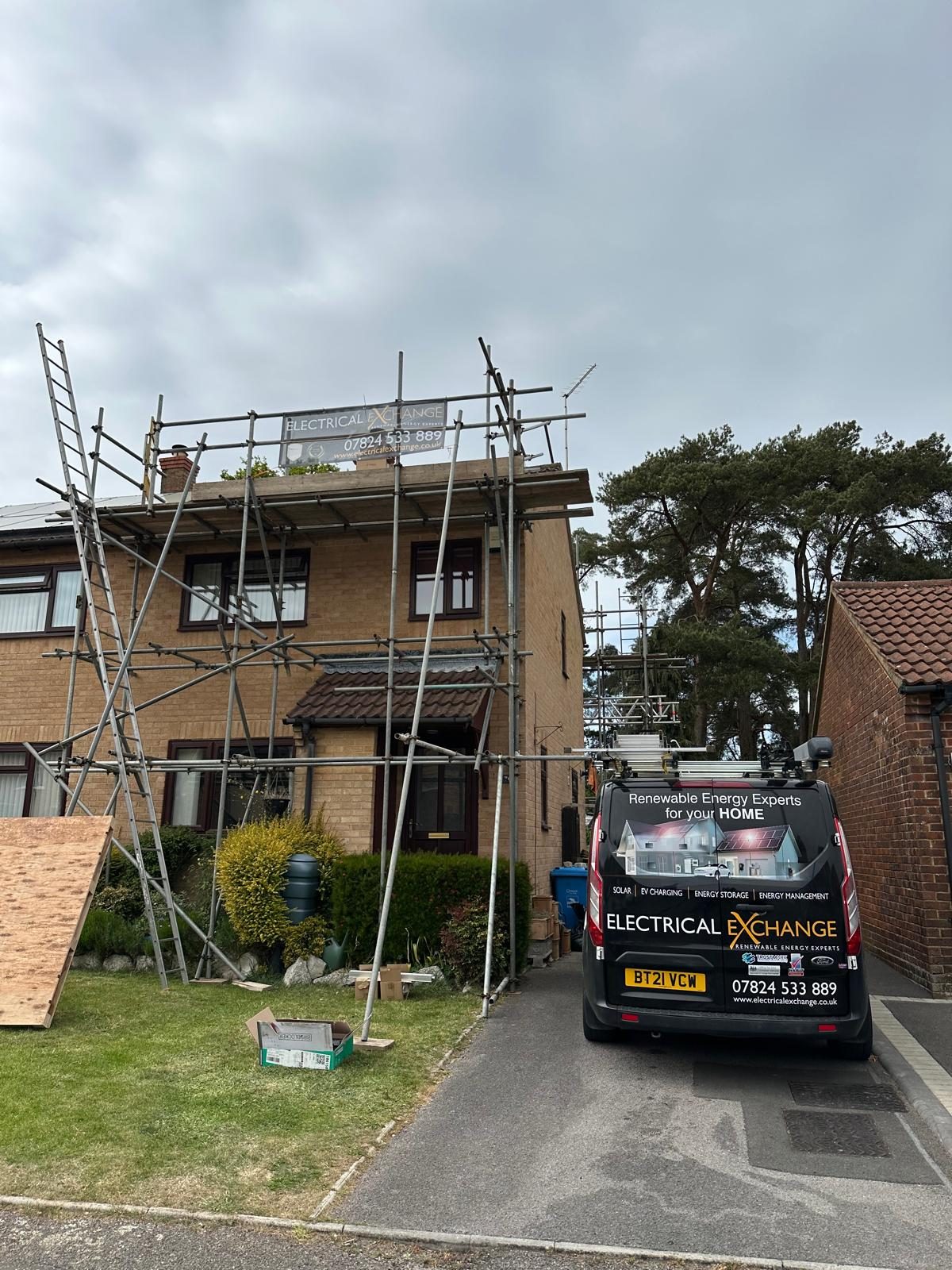 Electrical Exchange van and scaffolding at a solar panel installation in progress